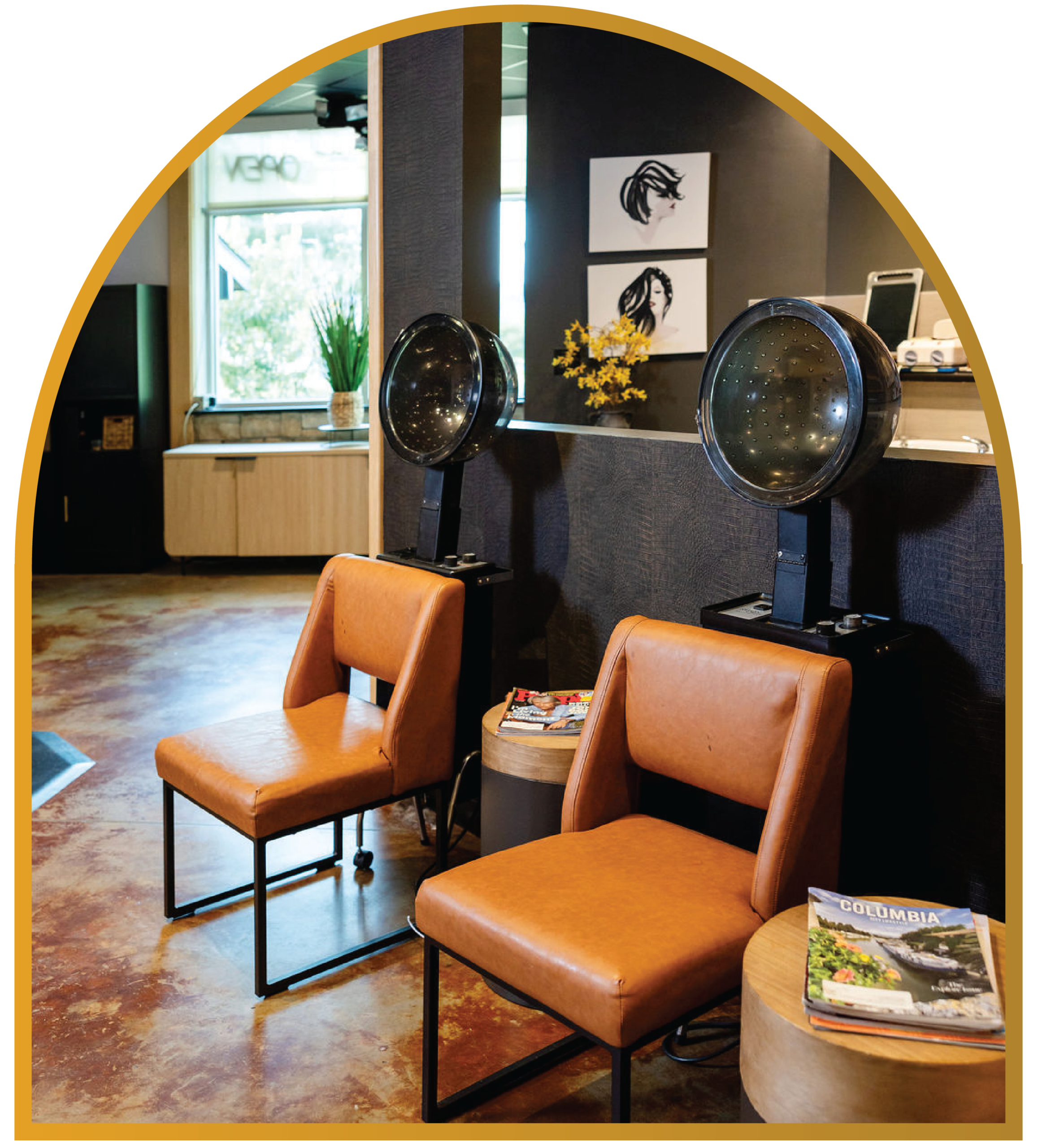 Thestrand-Homepgage-arch_Dryer-Chairs Hair drying station at The Strand Salon and Spa in Columbia, Missouri shows faux leather chairs and a stained concrete floor with dark walls with multiple chairs.