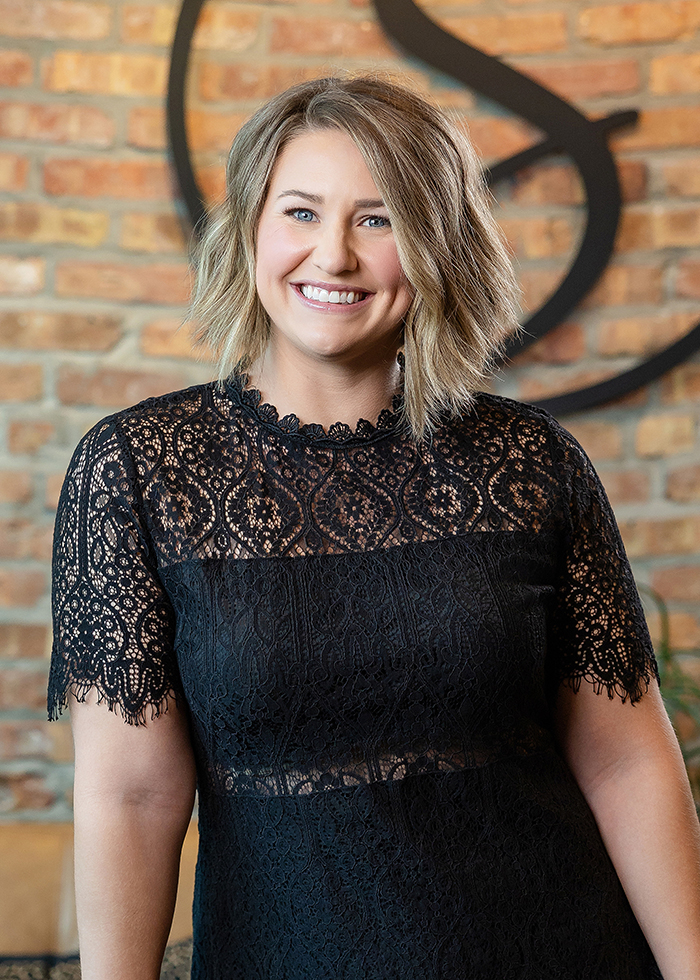 Madison_Veros-stylist-TheStrandSalonandSpa Portrait of stylist Madison Veros inside the waiting area at The Strand Salon and Spa in Columbia, Missouri.